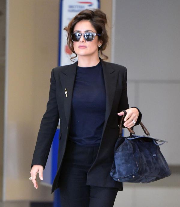 Salma Hayek looks smart and prim in the black trouser suit